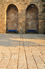 Ancient wall in Jaffa with alcoves for relaxation.