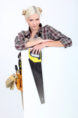 Blond woman with diy clothing and white sign for message