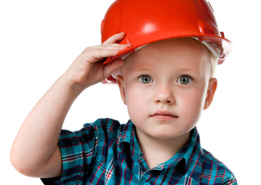 little boy in a red construction helmet