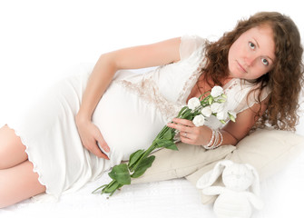 Obraz na płótnie Canvas Pregnant young woman lies