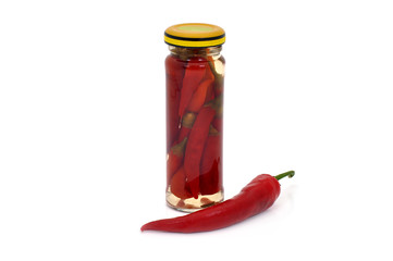 Preserved red hot pepper in a narrow glass jar
