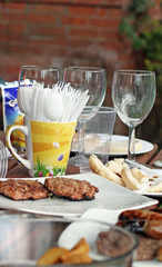 bbq table with meat glasses plates ect