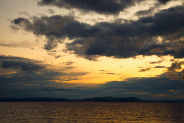 Fototapeta premium Sunset seascape. dark clouds in the sky