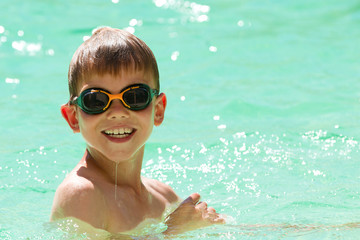 Young child swimming in the pool