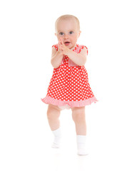 Baby in dress on a white background.
