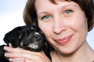 The woman with the puppy in her arms.