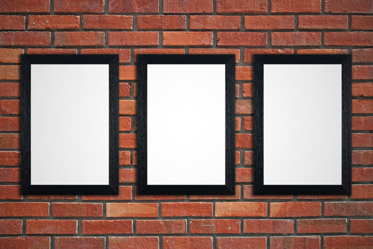 Frames on red brick wall