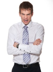 Angry young businessman isolated on white
