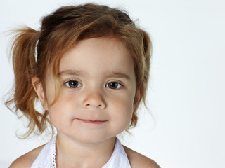 Portrait of adorable little girl with bright eyes smiling