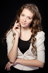 Portrait of beautiful female on black background