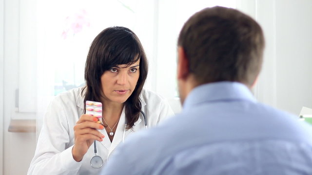 Female doctor recommending medications to male patient