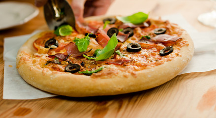 Closeup of homemade pizza with ham and tomatoes