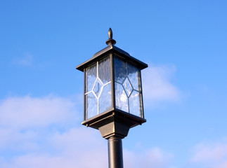 Street lamp in sunny day on a blue sky background