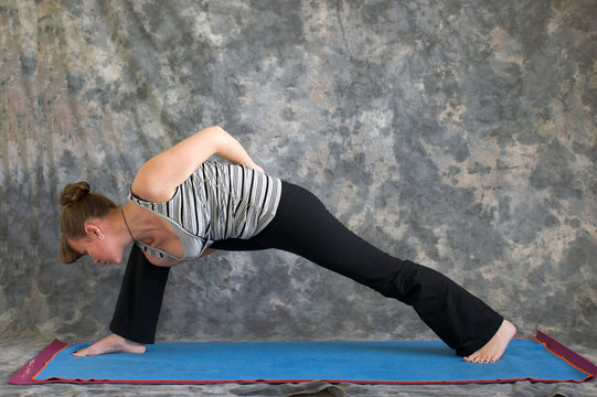 woman doing Yoga posture bound extended side angle pose - Powered by Adobe