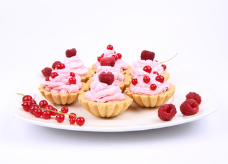 Tartlets with whipped cream and raspberries or redcurrants