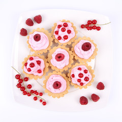 Tartlets with whipped cream and raspberries or redcurrants