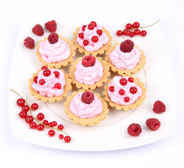 Tartlets with whipped cream and raspberries or redcurrants