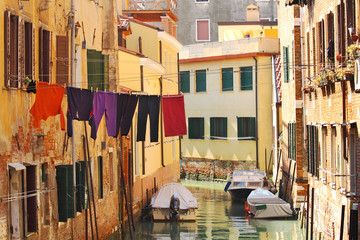 Fototapeta na wymiar Small canal among old houses in Venice, Italy.