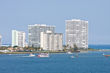 Boats Cruising Past Coastal Condos