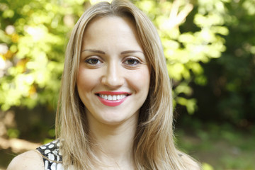 Fototapeta premium Closeup portrait of beautiful young woman smiling