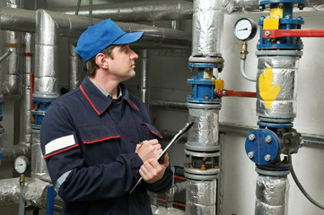 heating engineer repairman in boiler room