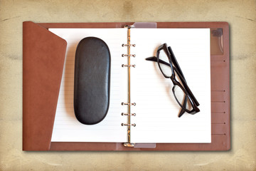 Reading glasses on notebook
