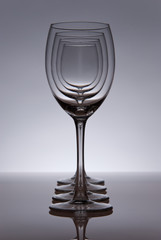 Four empty wine glasses in line