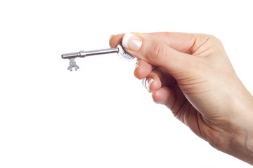 Hand holding key, isolated on white background.
