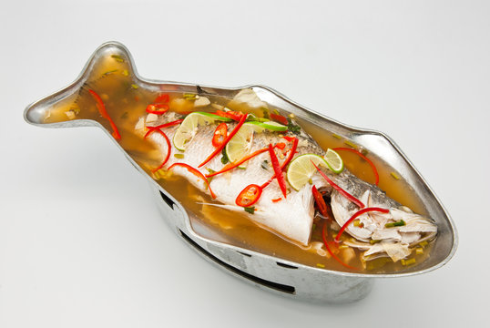 Steamed snapper fish with lemon on white background