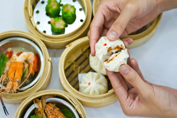 Steamed dumpling with hand