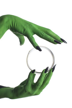 Green Witch's Hand Holding Crystal Ball, White Background.