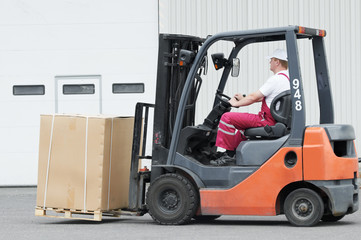 warehouse worker driver in forklift © Kadmy