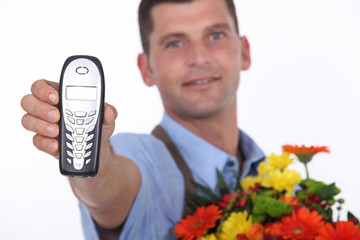 Florist holding forth a telephone