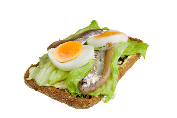 Open sandwich with egg, salad and anchovy