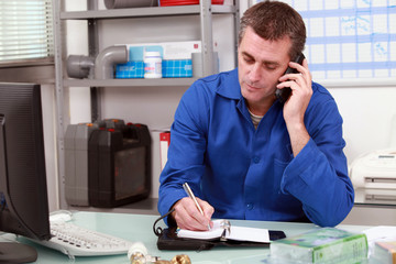 Plumber taking a call in an office