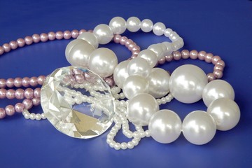 pearls and diamond on blue background