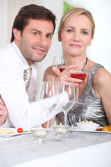 Romantic couple enjoying rose wine with dinner
