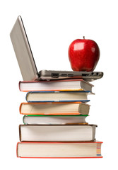 Red apple and computer on top of school books.