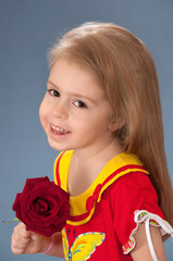 The little girl with a red rose.