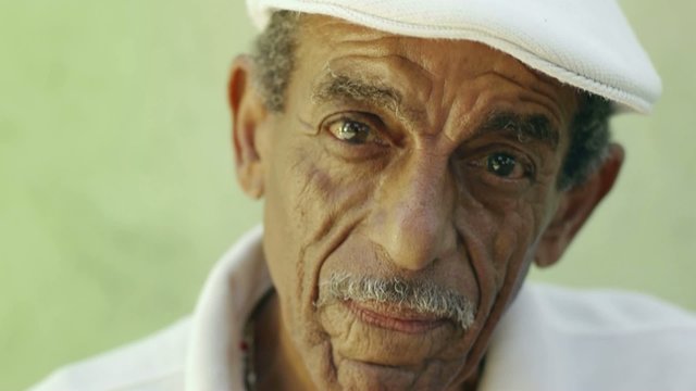 aged latino man smiling at camera