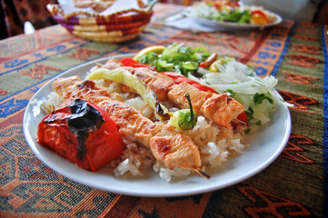 Chicken skewers with rice and vegetable salad in Turkey.