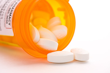 Prescription drug and pill bottle on white