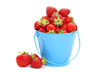 Strawberries in a bucket on a white background.