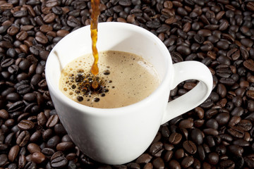 pour espresso, espresso coffee pouring into ceramic cup.