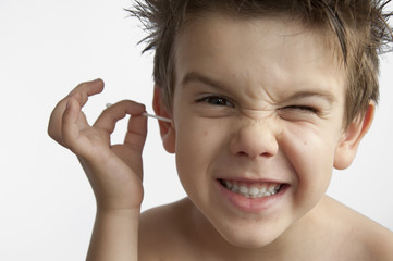 Boy cleans his ear