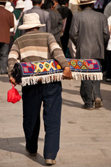 Old man walking with the carpet