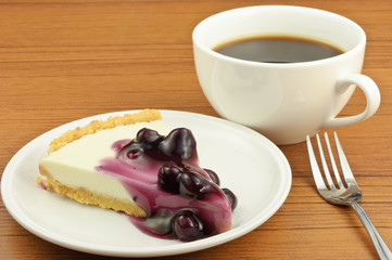 Blueberry cheese pie with coffee on table