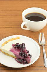 Blueberry cheese pie with coffee on table