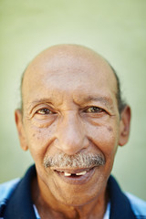 aged latino man smiling at camera