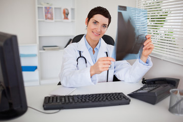 Smiling female doctor holding a set of X-ray